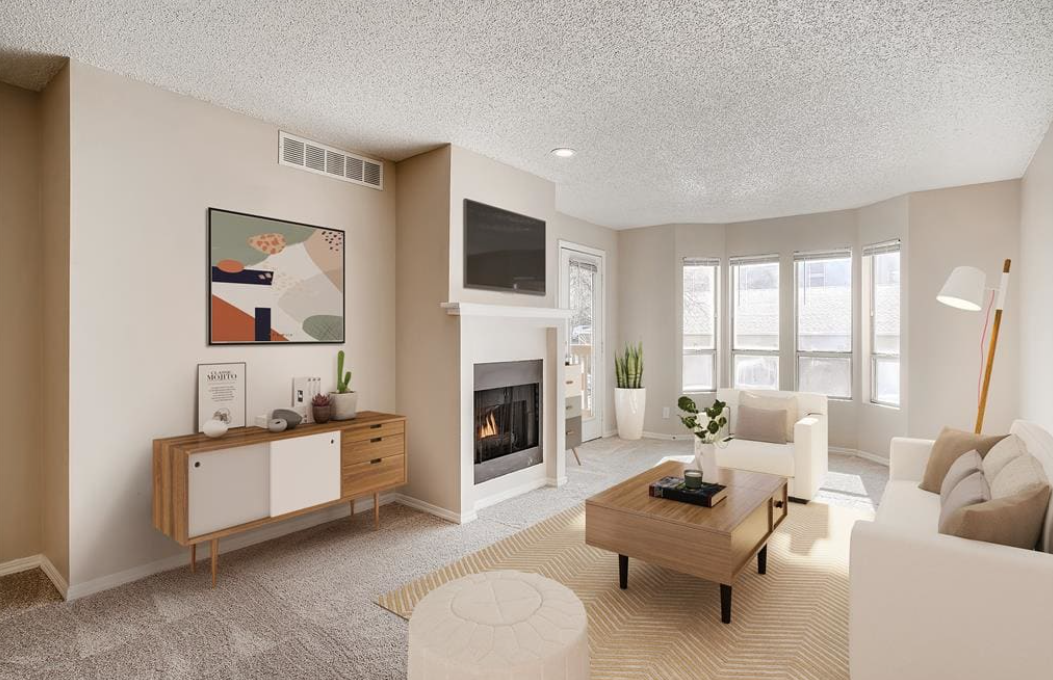 a living room with a fireplace and white furniture at The Residences at Bear Creek