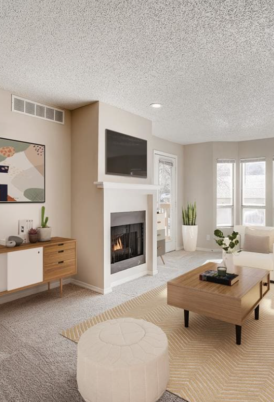 a living room with a fireplace and white furniture at The Residences at Bear Creek