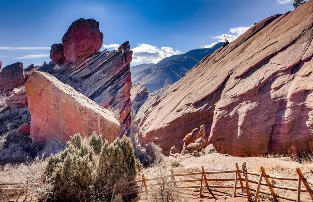 a fence and rocks in front of a mountain at The Residences at Bear Creek