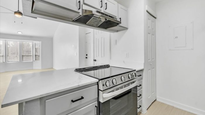 a white kitchen with a stove and oven at The Residences at Bear Creek