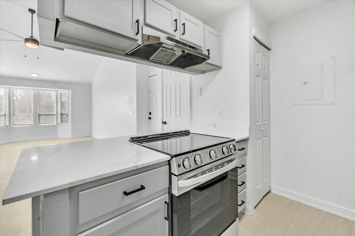 a white kitchen with a stove and oven at The Residences at Bear Creek