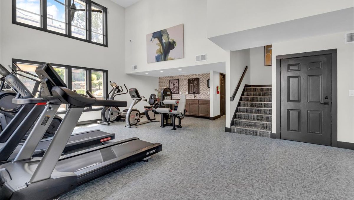 a gym with treadmills and exercise equipment at The Residences at Bear Creek