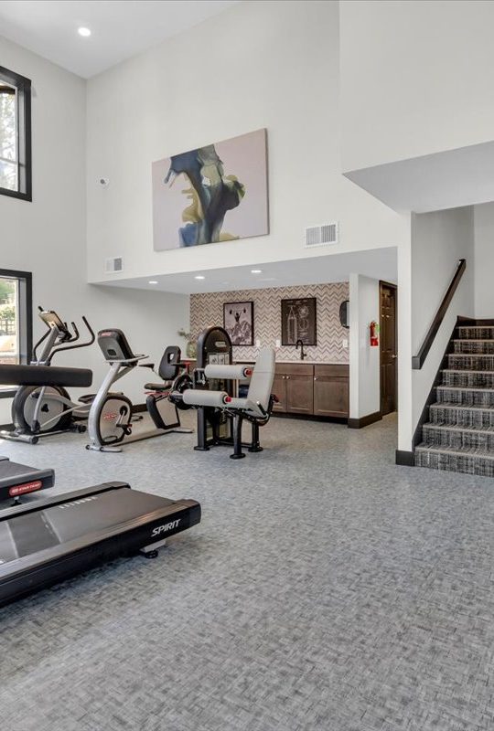 a gym with treadmills and exercise equipment at The Residences at Bear Creek