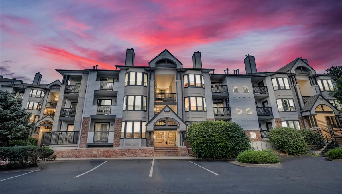 the sunset over an apartment complex in the mountains at The Residences at Bear Creek